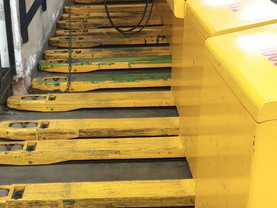 Row of electric pallet trucks
